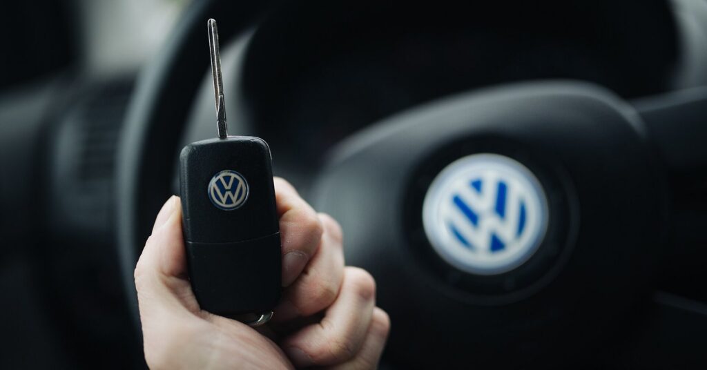 Hand holding car keys in a vehicle